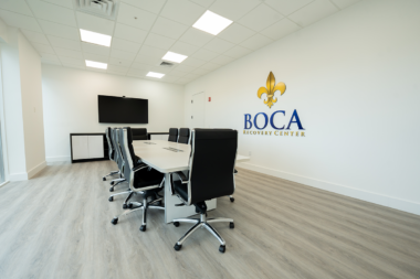 Modern conference room at Boca Recovery Center equipped with a large screen and meeting table.