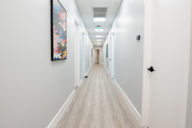 Long corridor inside the Boca Recovery Center clinic decorated with framed motivational art.