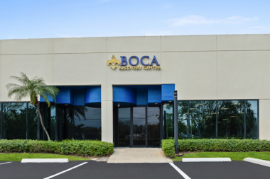 Front entrance of the Boca Recovery Center building with branded signage.
