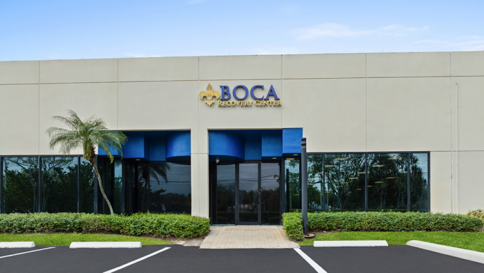 Front entrance of the Boca Recovery Center building with branded signage.