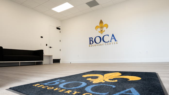 Boca Recovery Center lobby space featuring a branded welcome mat and matching 3D wall logo.