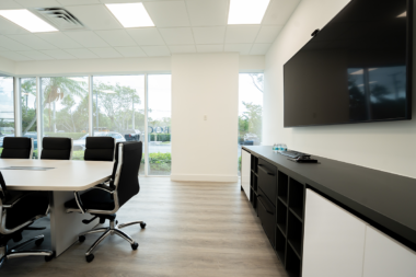 Boca Recovery Center boardroom looking toward large windows and a black and white credenza.
