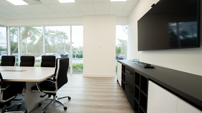 Boca Recovery Center boardroom looking toward large windows and a black and white credenza.