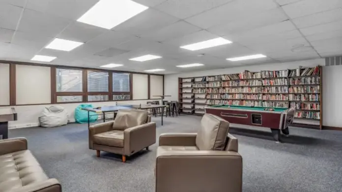 Game room at Woodland Grove Recovery with ping pong, pool, bookshelves, seating, and recreational space.