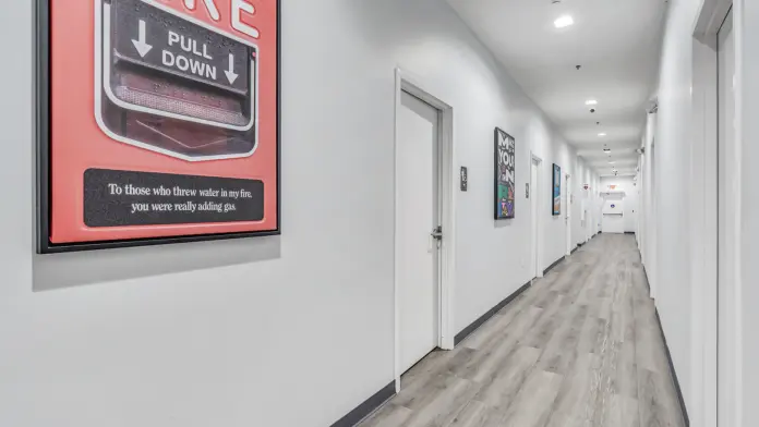 Inspirational artwork on the walls of Boca Recovery Center Huntington, featuring motivational quotes and colorful designs in a hallway.