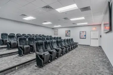 Spacious theater-style seating arrangement in Boca Recovery Center Huntington, designed for group sessions or presentations.