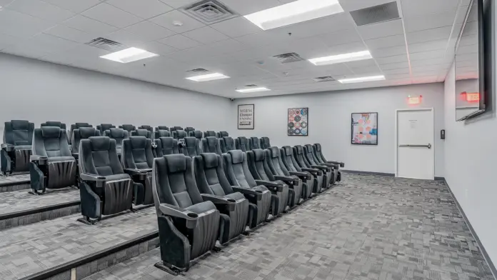 Spacious theater-style seating arrangement in Boca Recovery Center Huntington, designed for group sessions or presentations.