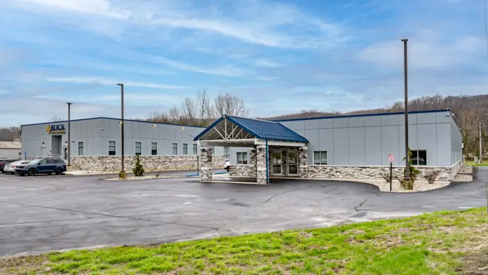 Exterior view of the Boca Recovery Center Huntington building with the front entrance and parking area.
