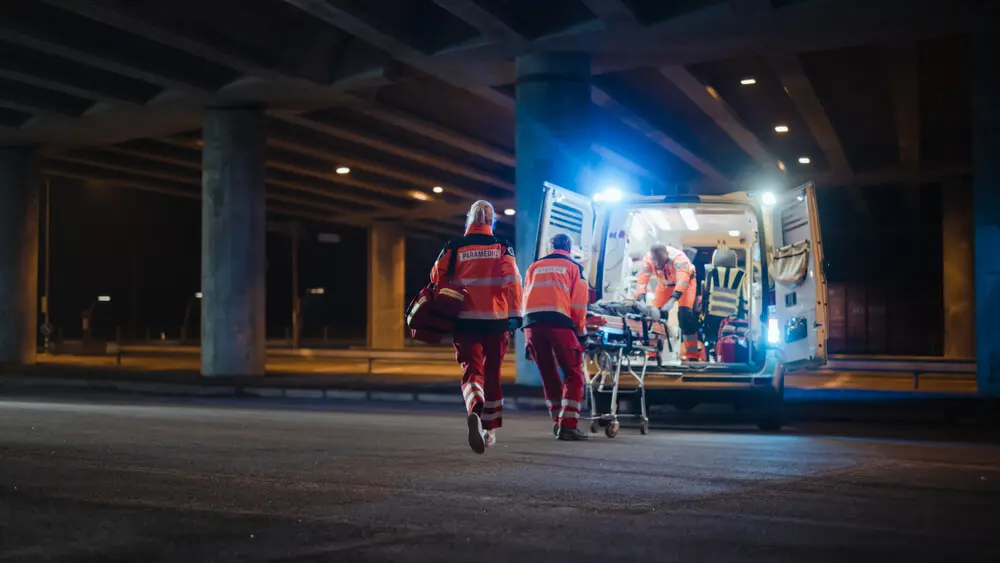 Paramedics rush someone into an ambulance after an overdose