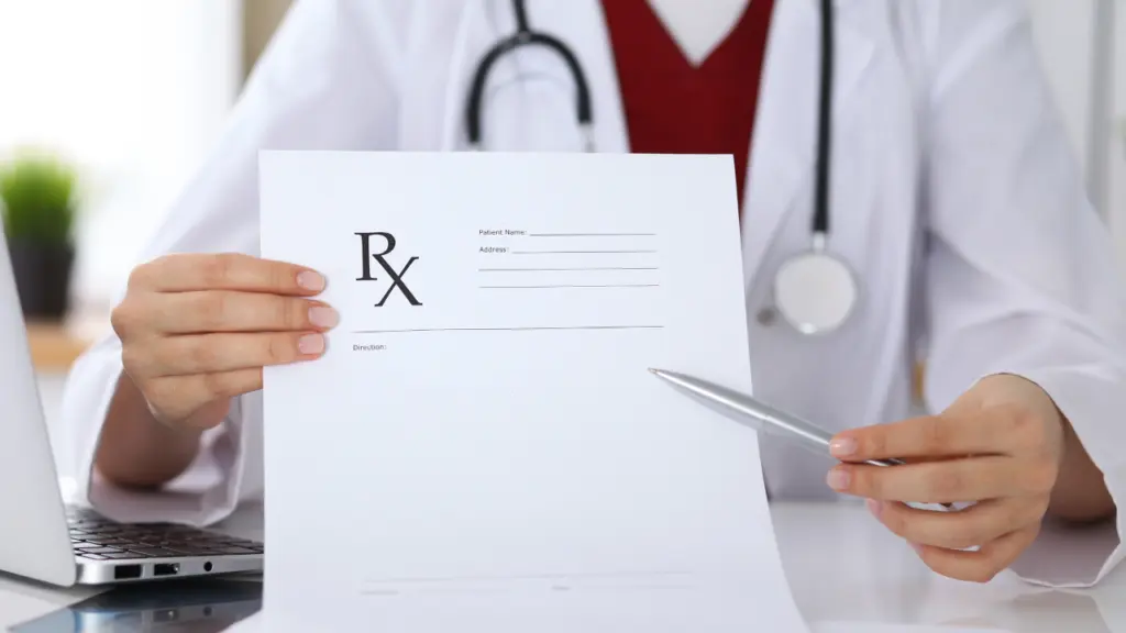 A doctor points to an RX prescription sheet