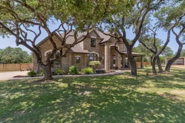 Exterior of Ava Recovery Center large house with tall trees