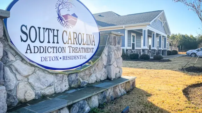 South Carolina Addiction Treatment center sign and building exterior on a sunny day. The large round sign reads