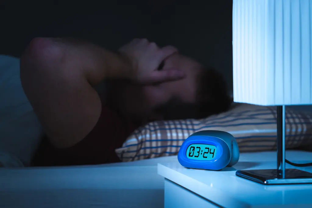 A man rubs his face after a long night of little to no sleep