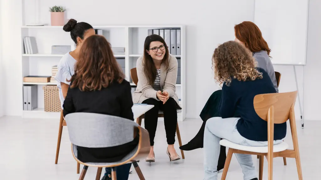 A group of people talk with eachother at an addiction support group