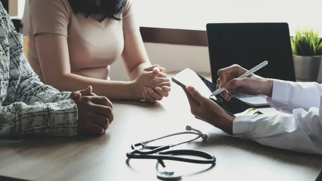 A doctor speaks with a patients during an appointment