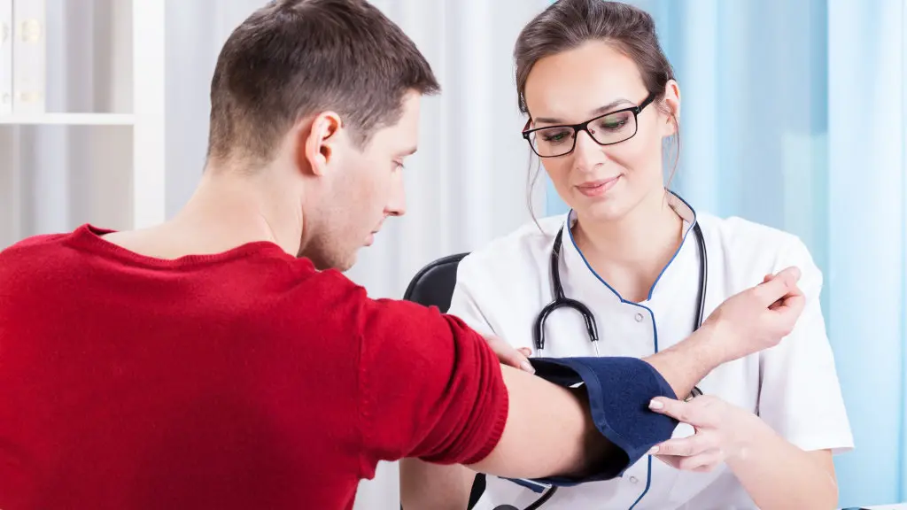 A doctor taking a patient's blood pressure during a checkup
