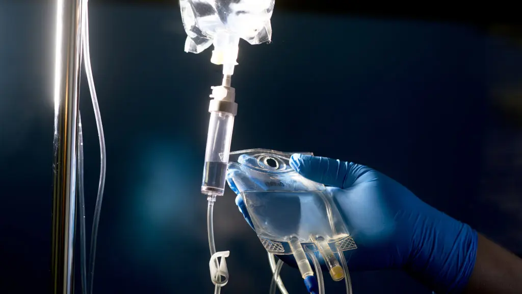 A gloved hand prepares and IV drip medication. Certain drugs used in alcohol withdrawal recovery are administered intravenously