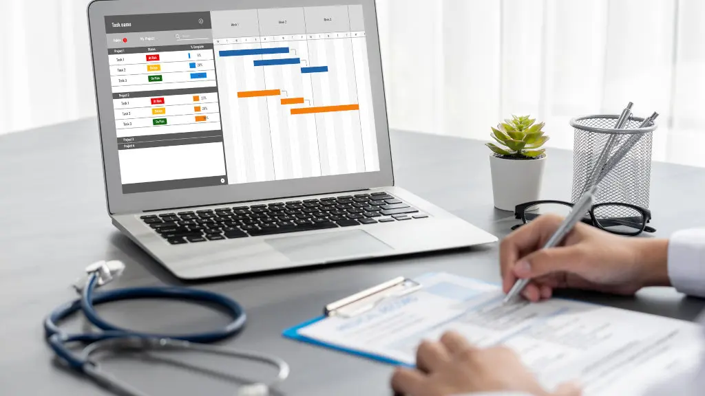 A doctor analyzes various recovery and treatment timelines on a laptop