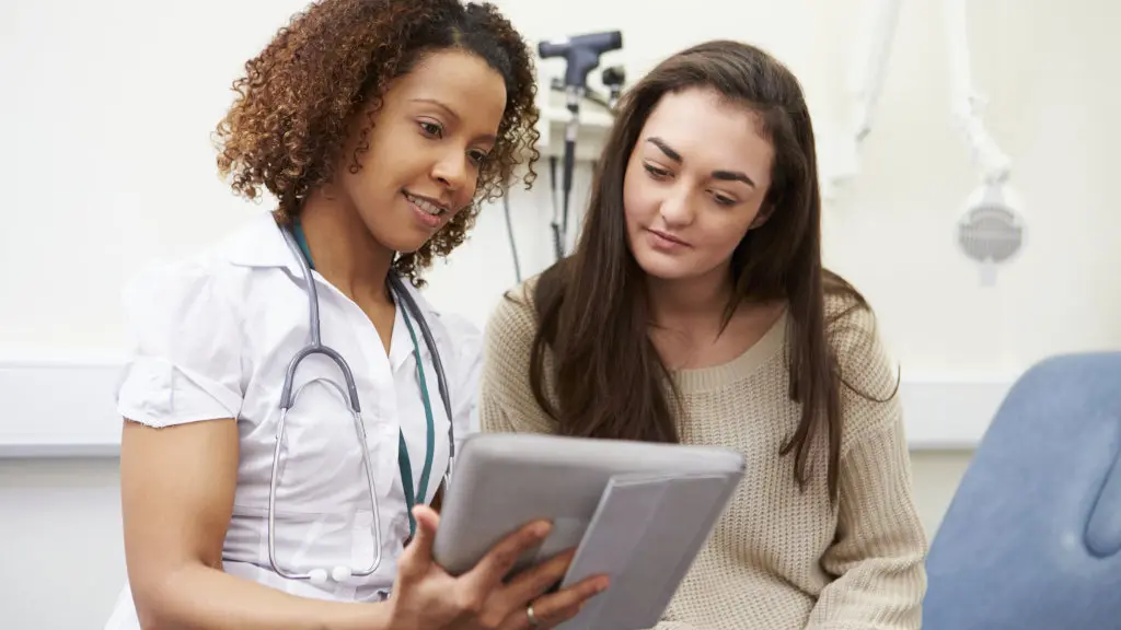 A doctor speaks with a patient about a naltrexone prescription during an appointment