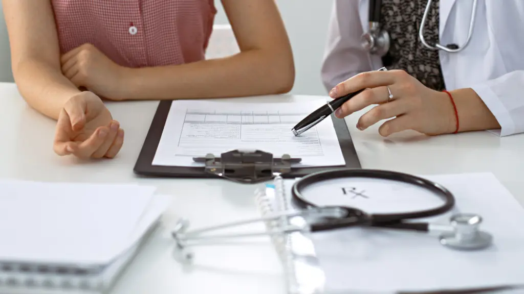 A doctor speaks with a patient about a prescription for naltrexone, to treat alcohol withdrawal