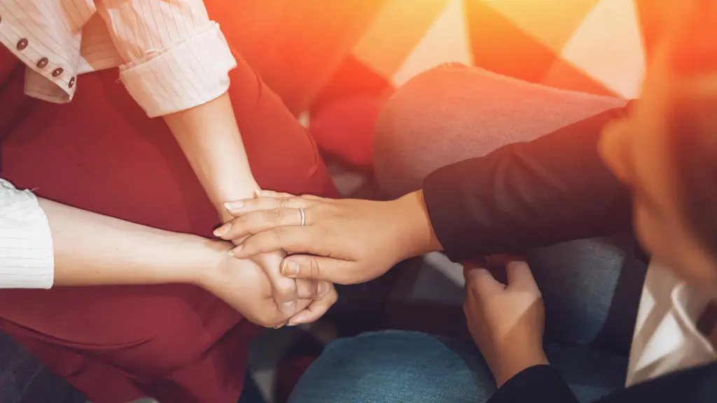 A person consoles another during a visit to the doctor's office