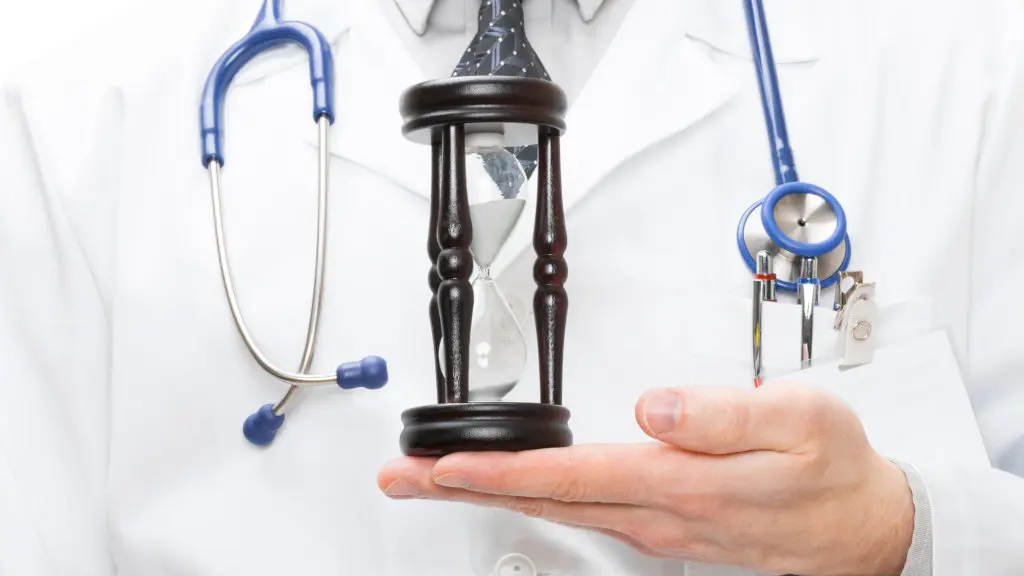 A doctor holding an hourglass
