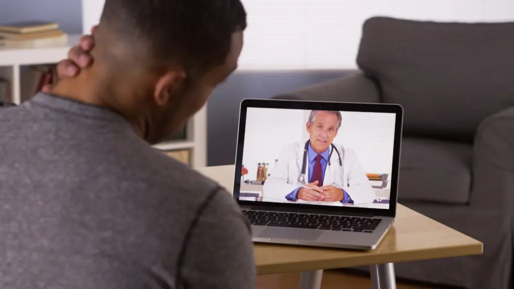 A patient speaks with a doctor via telehealth. Learn more about how to get methadone treatment online, here.