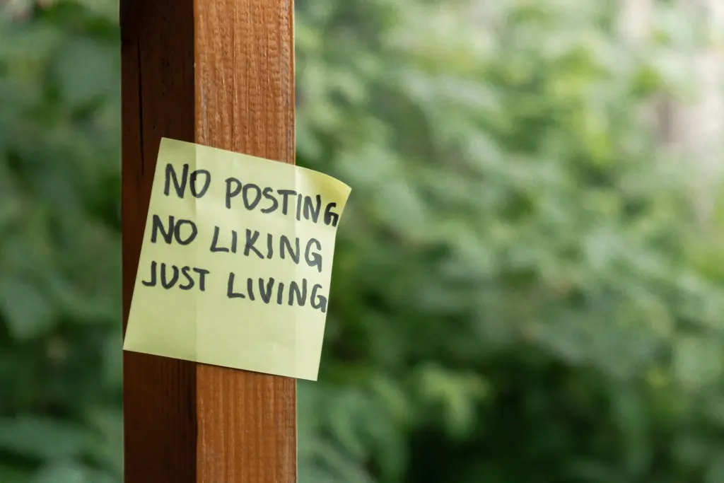 a sticky note that says "no posting, no liking, just living"