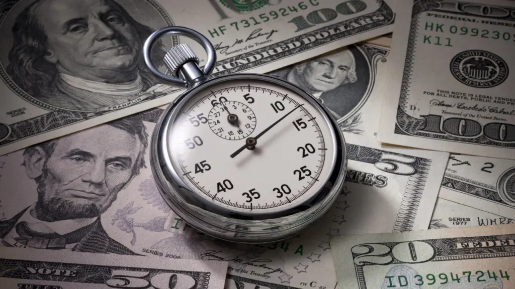 a stopwatch sitting on top of a pile of US dollars. Learn more about rapid detox here.