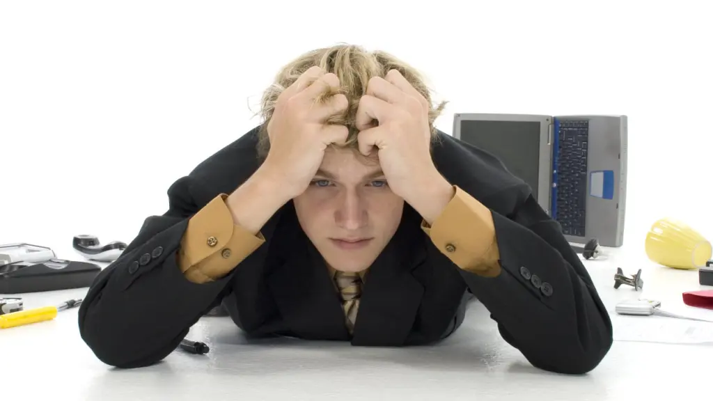 A stressed man grips his hair. Learn more about vyvanse withdrawal here.