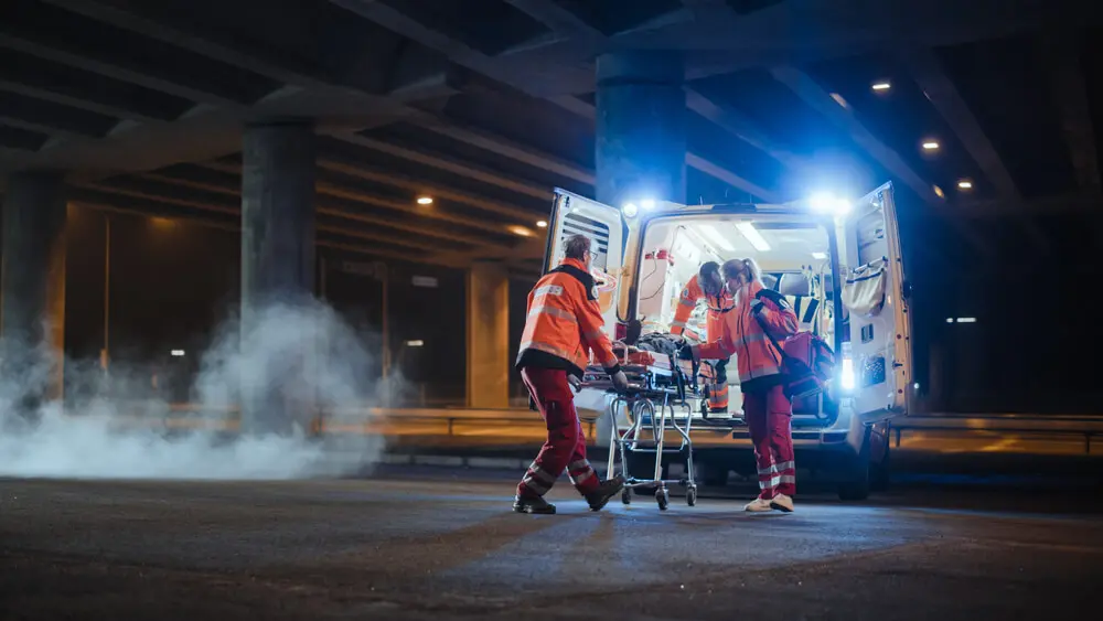 Paramedics wheel someone into an ambulance. Learn more about xylazine overdoes here