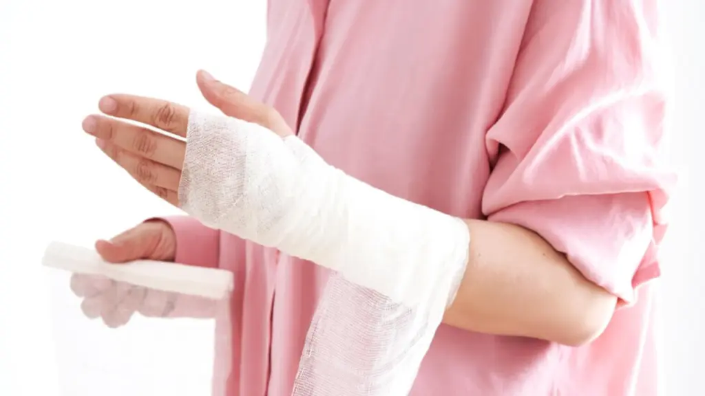 A person wraps their arm with a bandage. Learn more about xylazine wounds and necrosis here.
