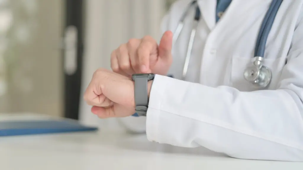A doctor checks their watch. Learn more about protracted benzodiazepine withdrawal (PAWS) here