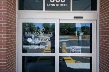 Exterior entrance showing 860 Lynn Street address on brick building with glass doors and facility signage