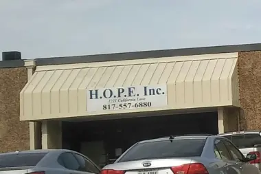 Exterior storefront showing H.O.P.E. Inc. signage, address at 1221 California Lane, phone number, and parking area with vehicles