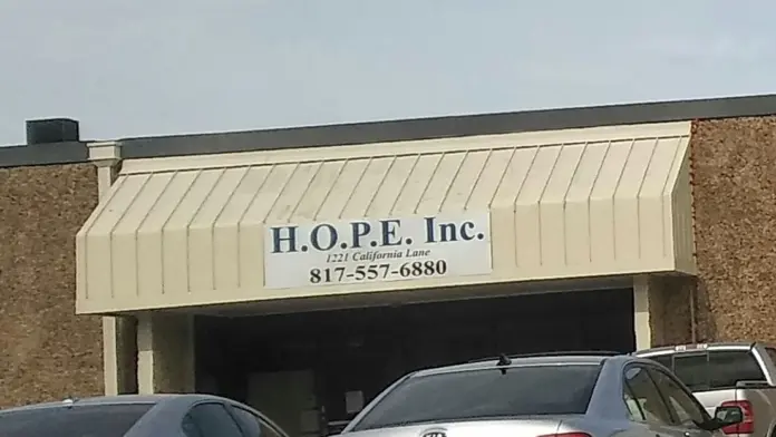Exterior storefront showing H.O.P.E. Inc. signage, address at 1221 California Lane, phone number, and parking area with vehicles