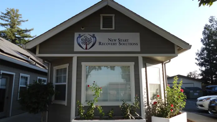 Exterior view of New Start Recovery Solutions building with signage, entrance, landscaping, and parking area
