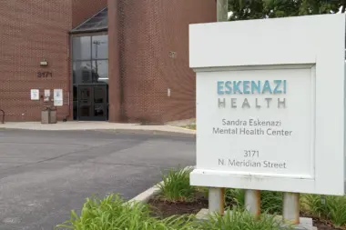 Exterior view of Sandra Eskenazi Mental Health Center brick building with white entrance sign displaying facility name and address at 3171 N. Meridian Street