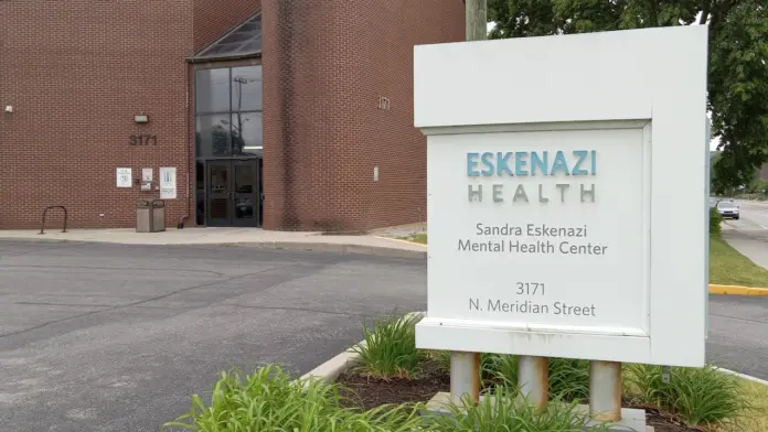 Exterior view of Sandra Eskenazi Mental Health Center brick building with white entrance sign displaying facility name and address at 3171 N. Meridian Street
