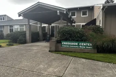 Exterior front entrance of mental health treatment center with covered portico, facility signage, and landscaping