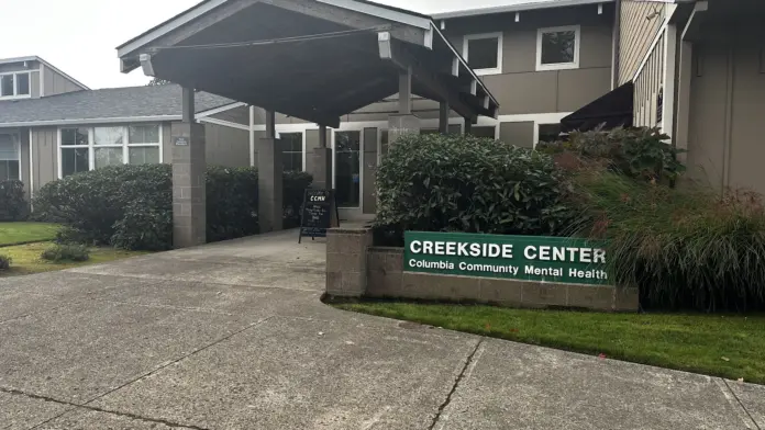 Exterior front entrance of mental health treatment center with covered portico, facility signage, and landscaping