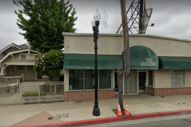 Exterior front facade of Teen Challenge facility showing green awning with facility name, brick and stucco construction, street-level storefront entrance