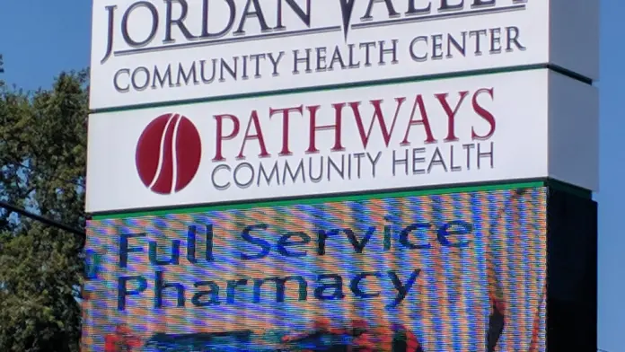 Exterior roadside sign displaying Jordan Valley Community Health Center and Pathways Community Health branding with digital message board