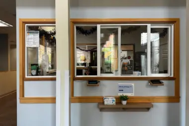 Interior service window with wooden frame glass panes and signage