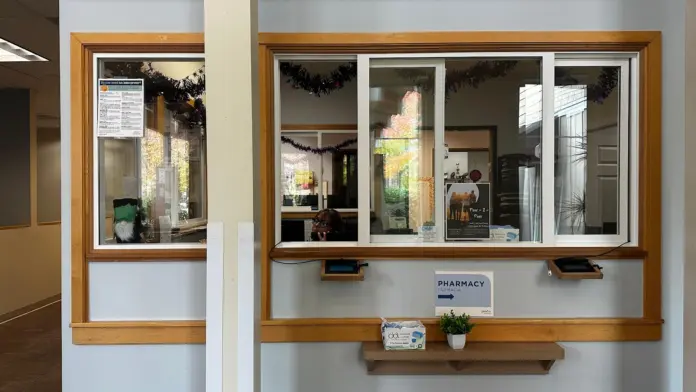 Interior service window with wooden frame glass panes and signage
