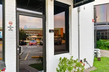 Exterior front facade showing modern white building with black trim and address number 17250 displayed on corner