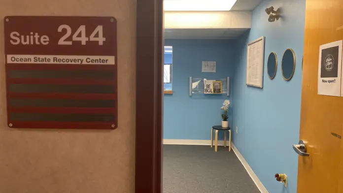 Interior hallway showing Suite 244 sign for Ocean State Recovery Center with blue and yellow accent walls